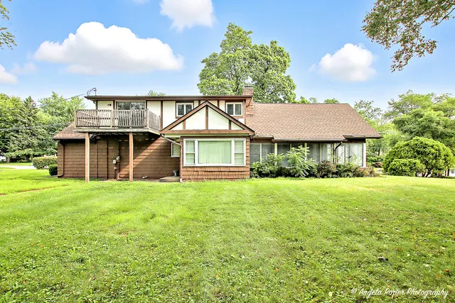 an aerial view of residential house with pool and yard
