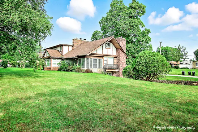a view of a house with yard and a garden