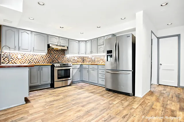 a kitchen with a sink cabinets and oven