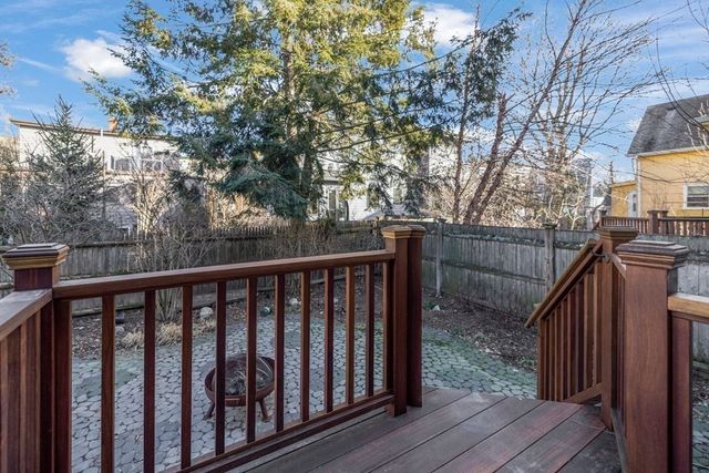 a balcony with wooden floor and wooden fence