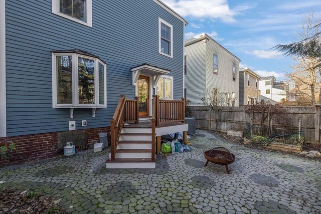 a view of a house with backyard and chairs