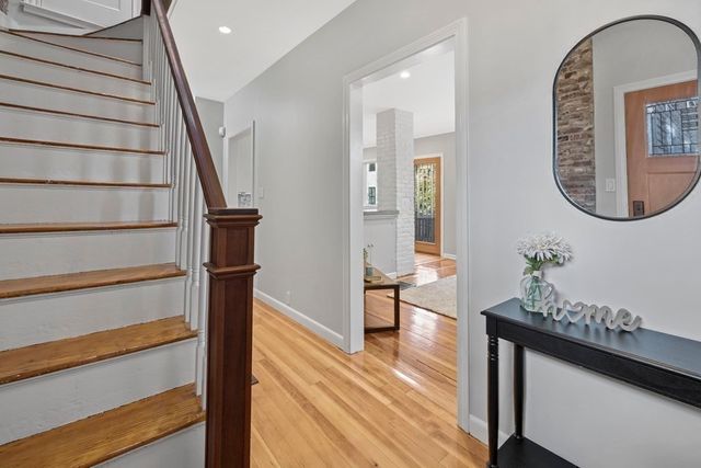 a view of an entryway with wooden floor and front door