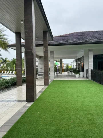 a view of a house with backyard porch and sitting area