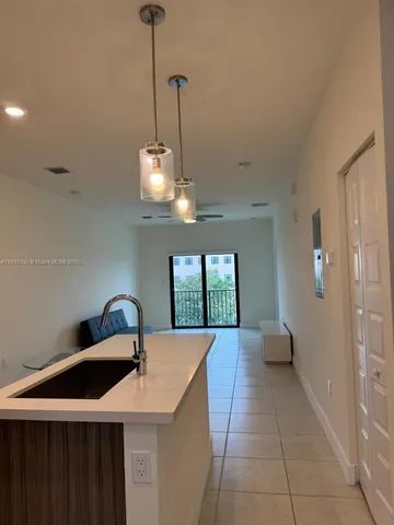 a very nice looking room with a chandelier furniture and windows