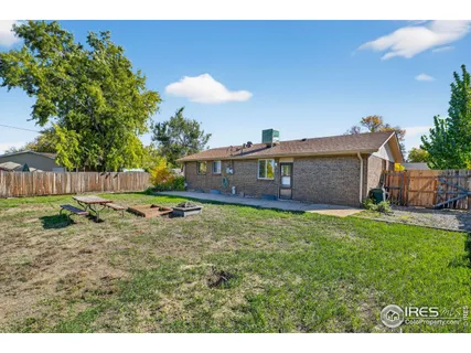 a backyard of a house with table and chairs