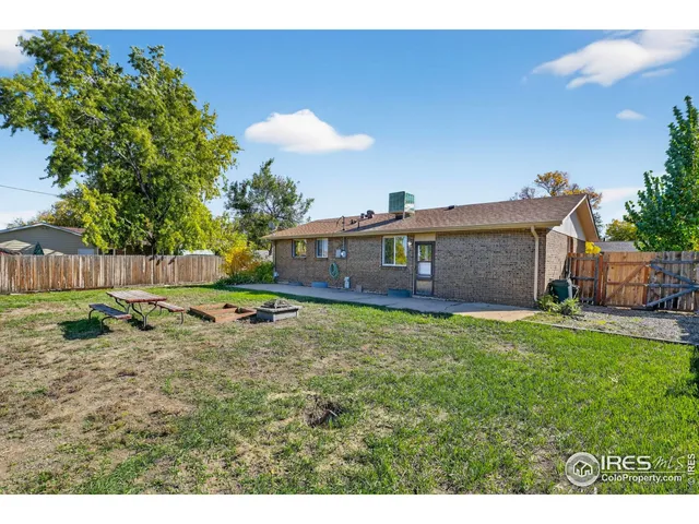 a backyard of a house with table and chairs