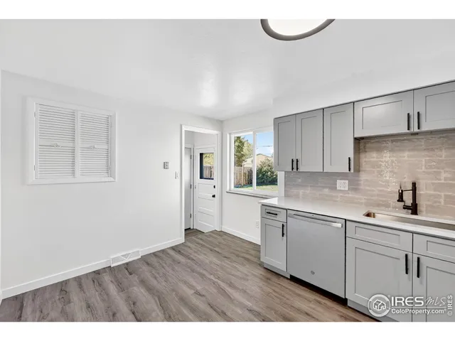 a kitchen with a sink cabinets and window