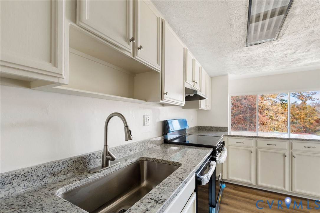 1501 Largo Road, Unit 301 Henrico, VA 23238 - Photo 15 of 40 a kitchen with granite countertop a sink a counter space and cabinets