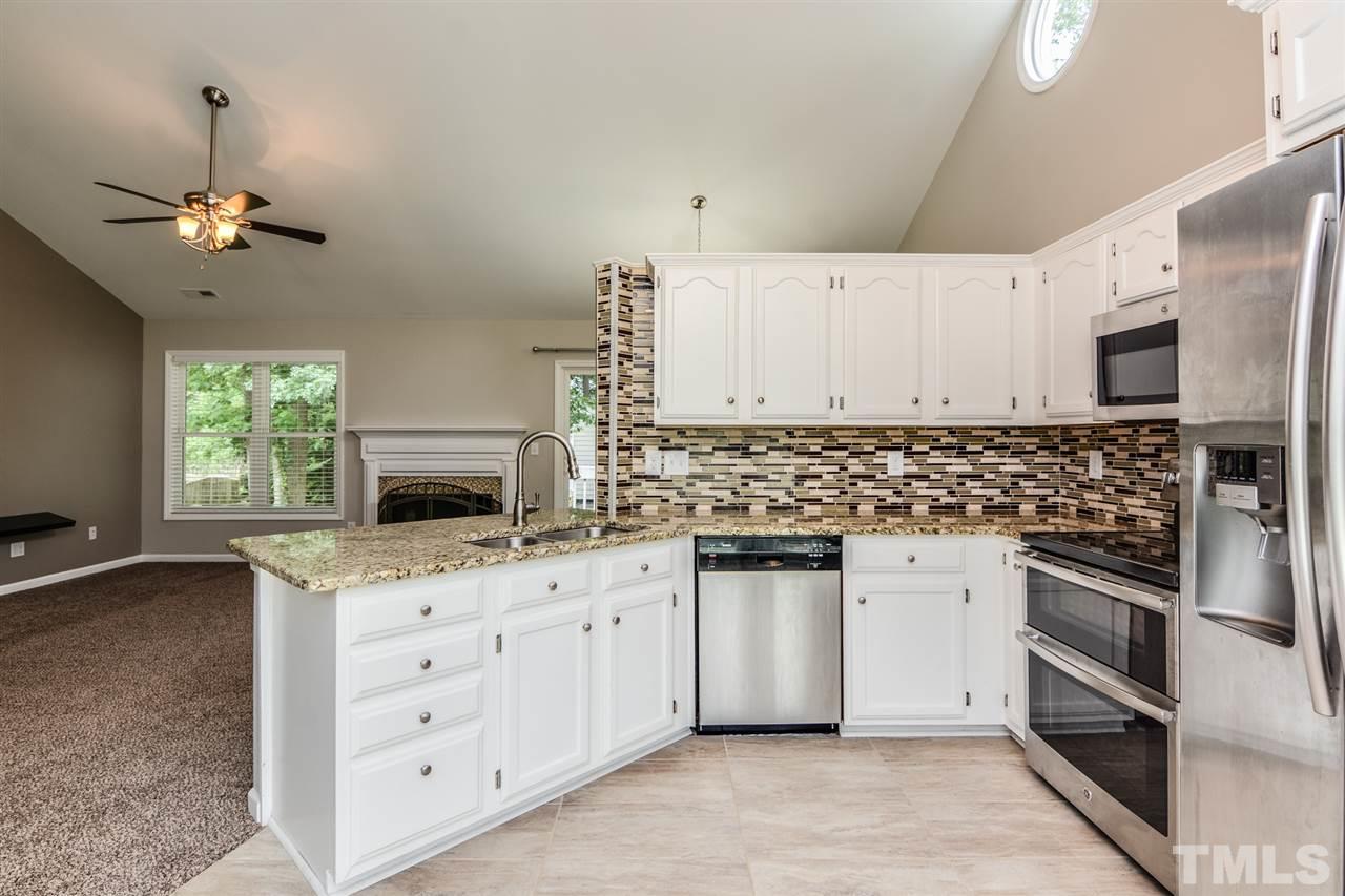 3628 Epperly Court Raleigh, NC 27616 - Photo 2 of 18 a kitchen with granite countertop a stove oven and a sink with dishwasher