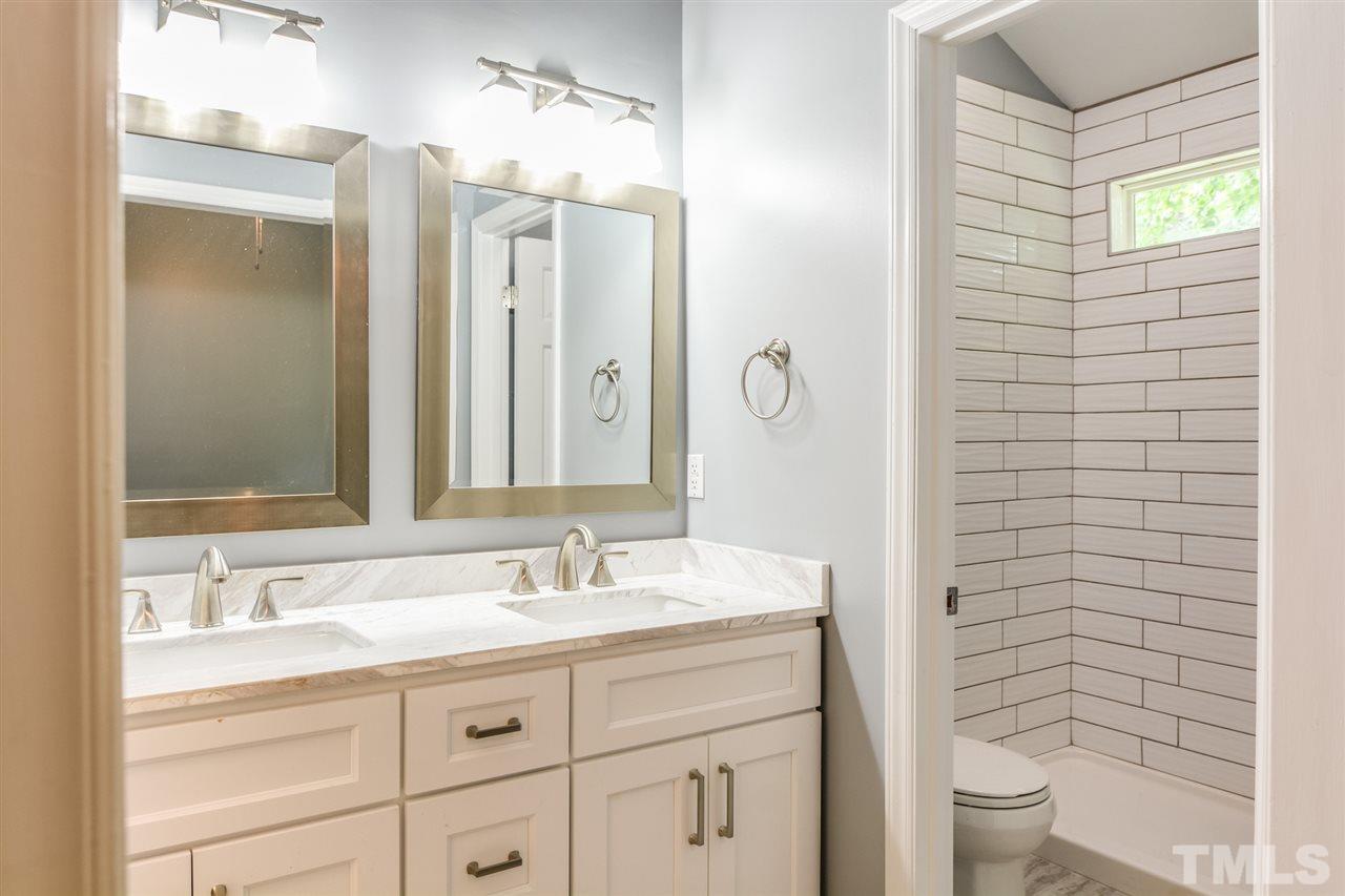 3628 Epperly Court Raleigh, NC 27616 - Photo 12 of 18 a bathroom with a double vanity sink toilet and shower