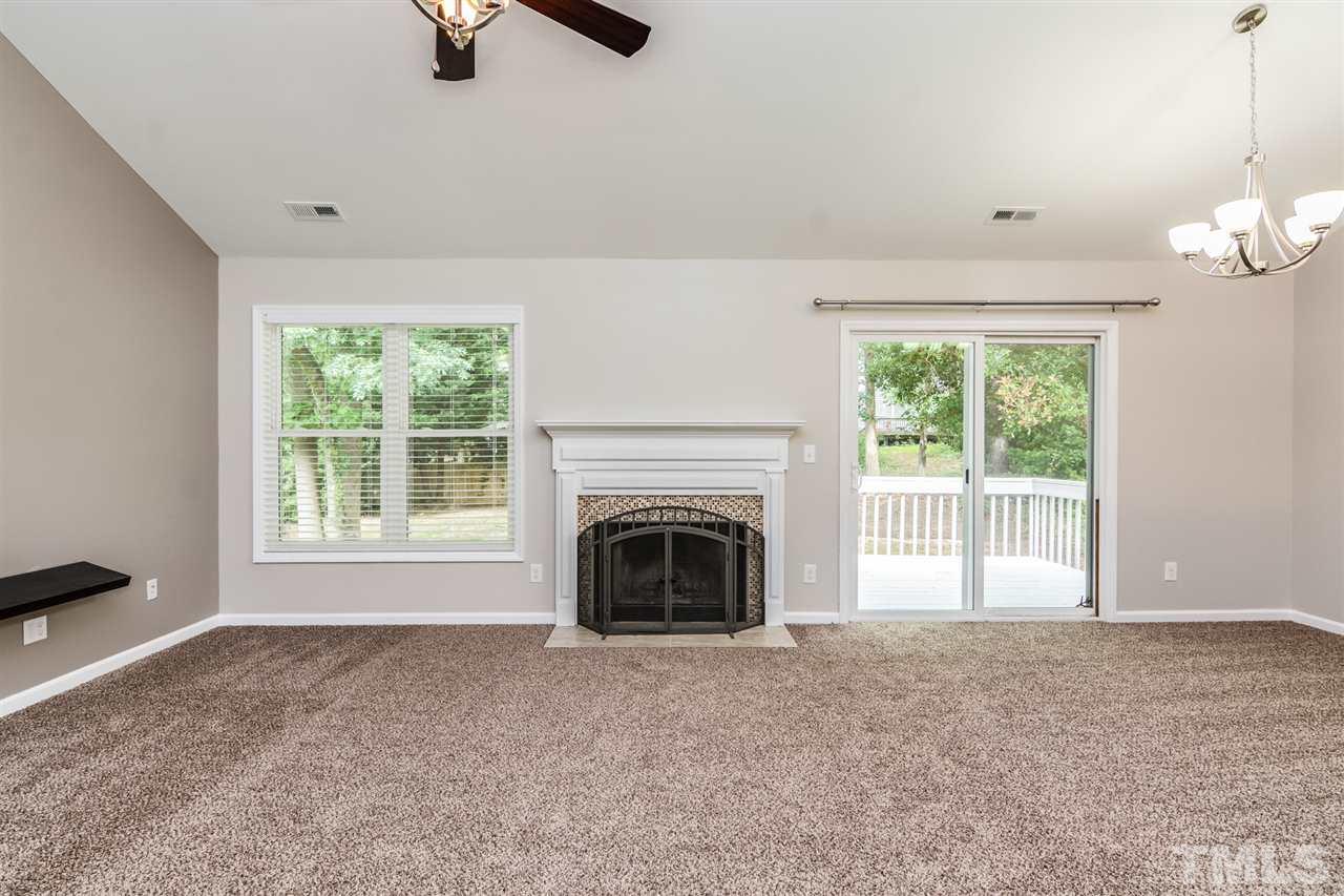 3628 Epperly Court Raleigh, NC 27616 - Photo 3 of 18 en empty room with windows and fireplace