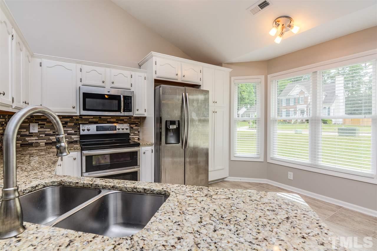 3628 Epperly Court Raleigh, NC 27616 - Photo 6 of 18 a kitchen with a sink a refrigerator and a stove top oven