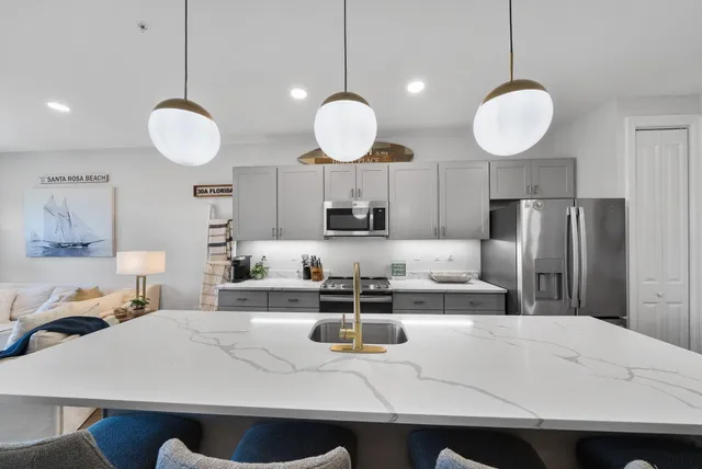 a kitchen with a sink dishwasher a stove top oven a counter space and cabinets