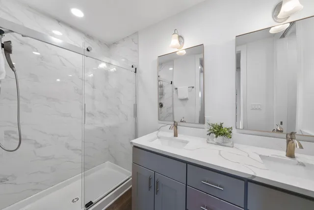 a bathroom with a sink double vanity and a mirror
