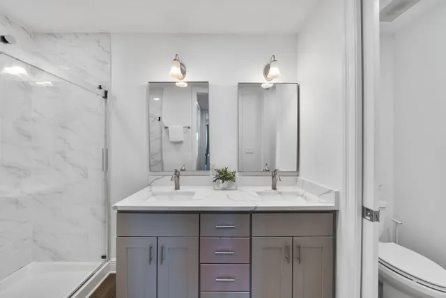 a bedroom with two beds and painting on the wall