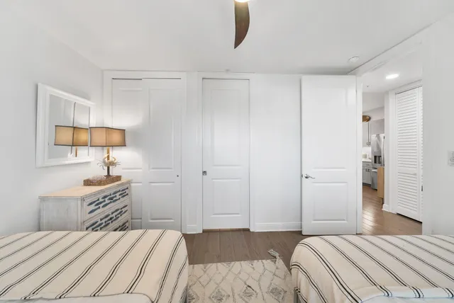 a bathroom with a granite countertop sink mirror vanity and a toilet