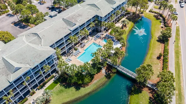 an aerial view of residential house with outdoor space and trees all around