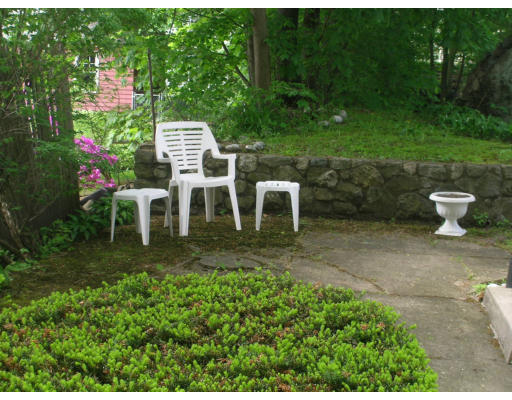 12 Benjamin Road Arlington, MA 02476 - Photo 7 of 11 a view of a backyard with table and chairs and potted plants