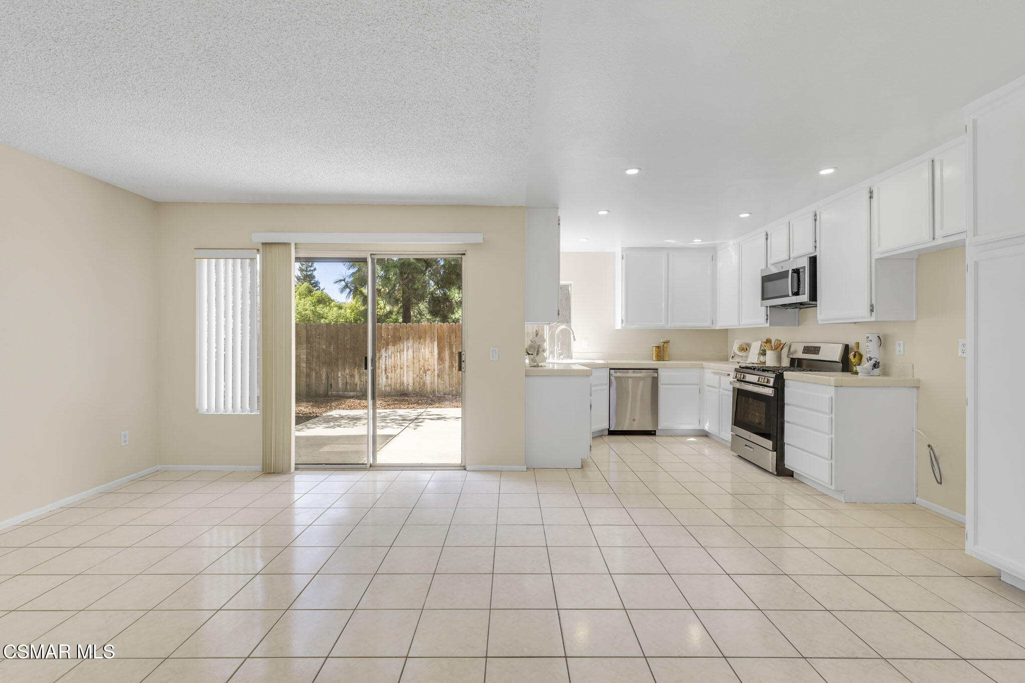 6635 Pecan Avenue Moorpark, CA 93021 - Photo 12 of 54 a large white kitchen with a stove a sink dishwasher and a refrigerator with white cabinets