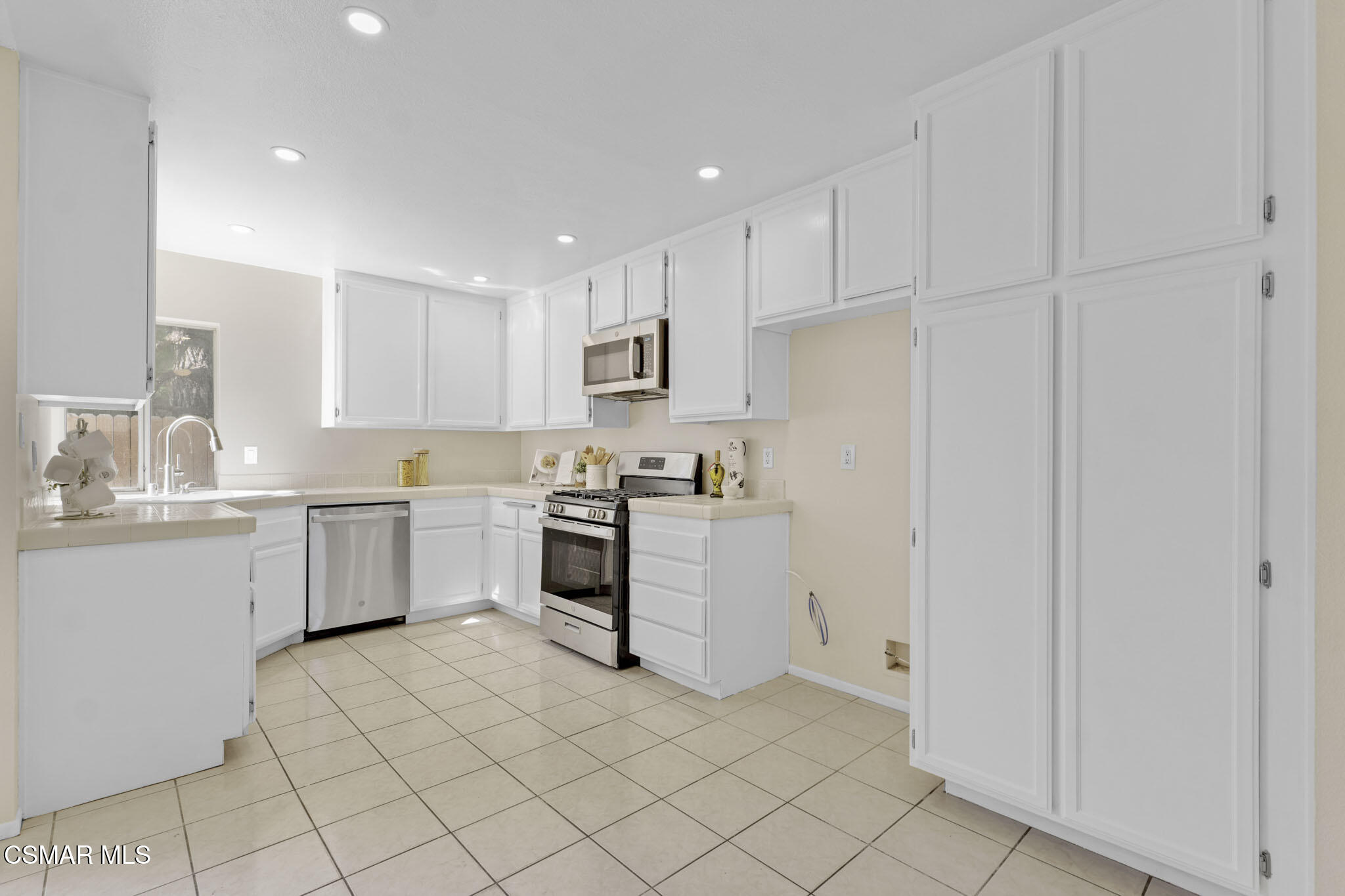 6635 Pecan Avenue Moorpark, CA 93021 - Photo 15 of 54 a kitchen with white cabinets and white appliances
