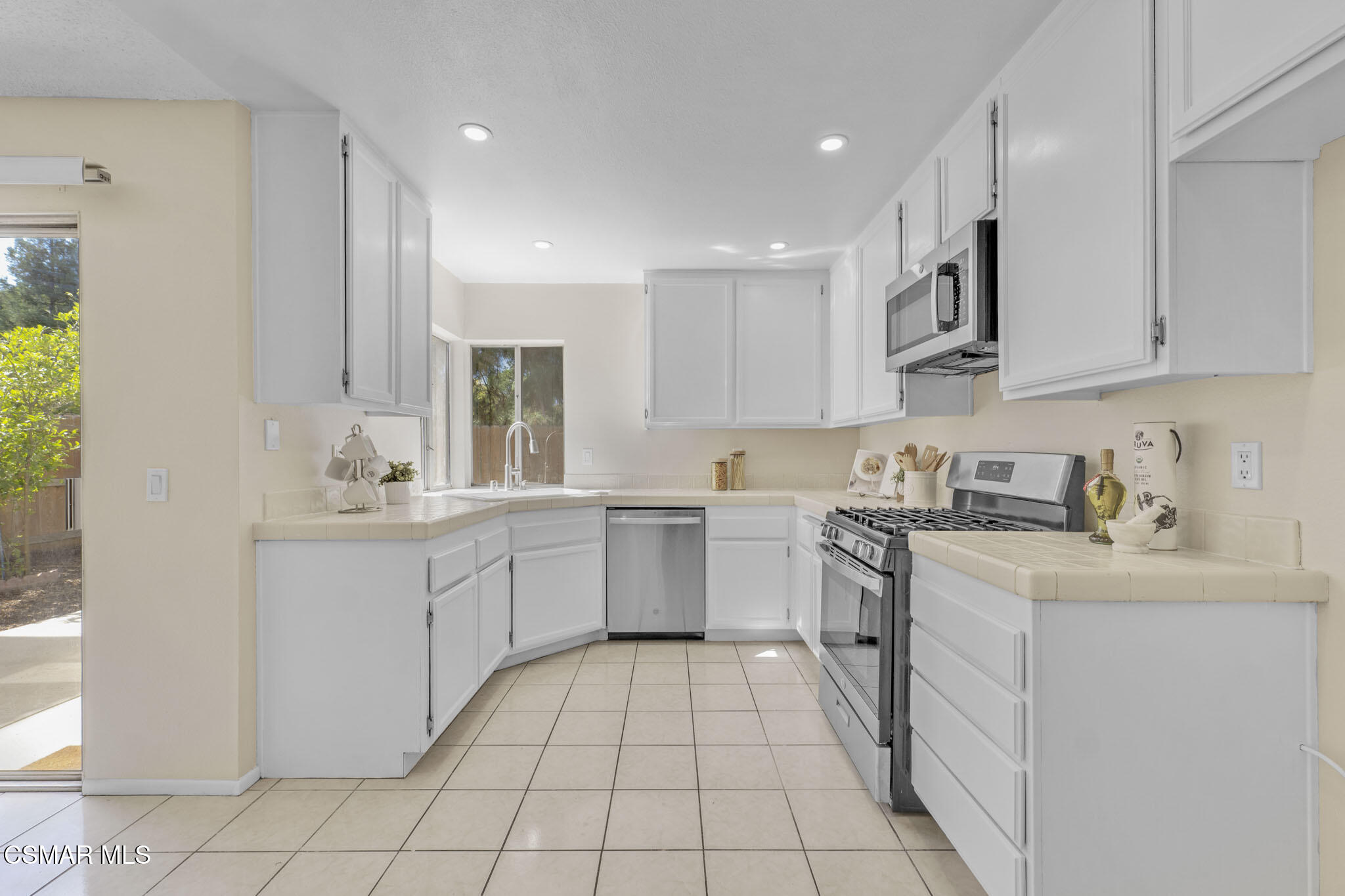 6635 Pecan Avenue Moorpark, CA 93021 - Photo 16 of 54 a kitchen with a sink stove and cabinets