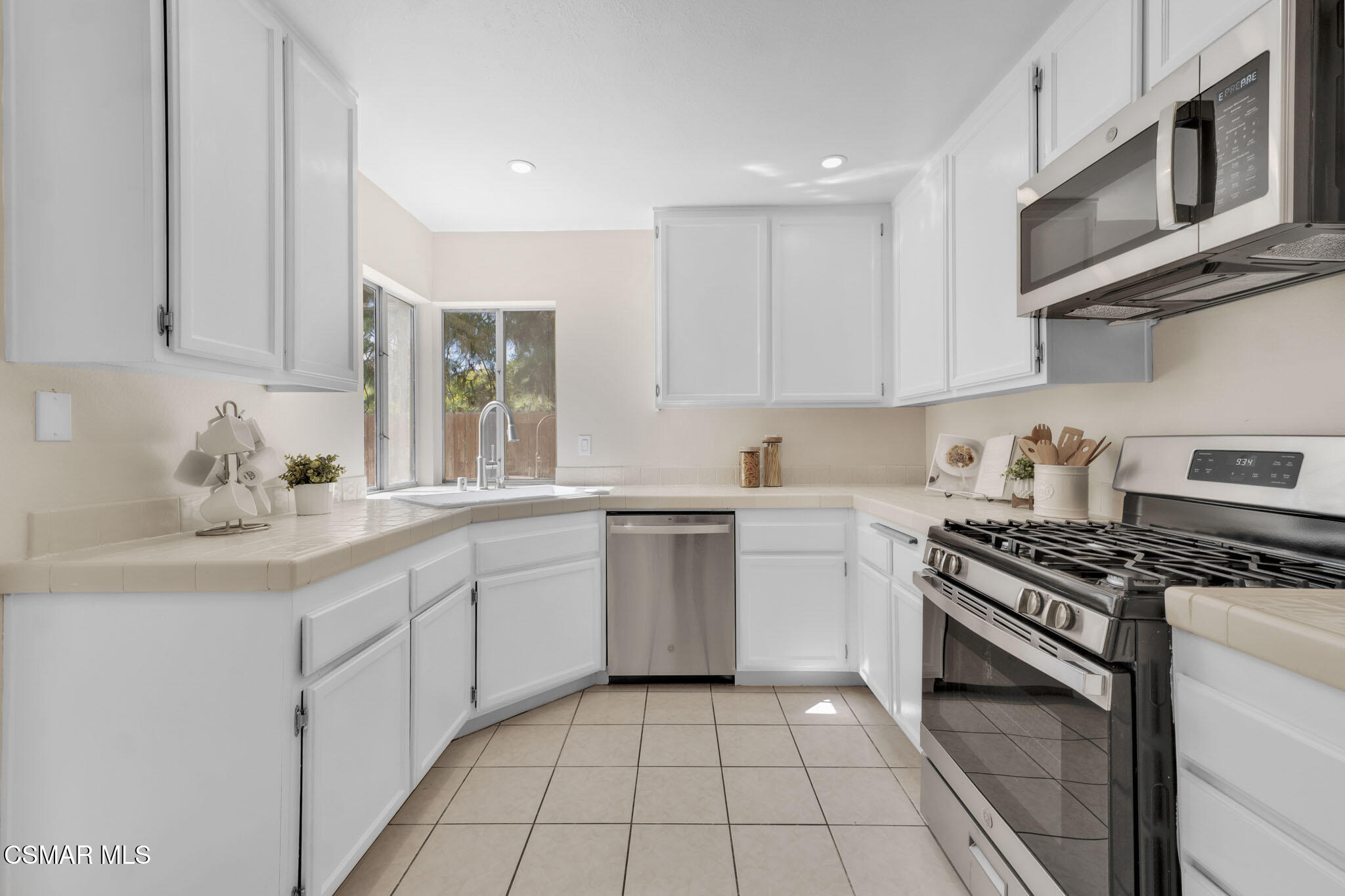 6635 Pecan Avenue Moorpark, CA 93021 - Photo 17 of 54 a kitchen with stainless steel appliances granite countertop a stove and a sink