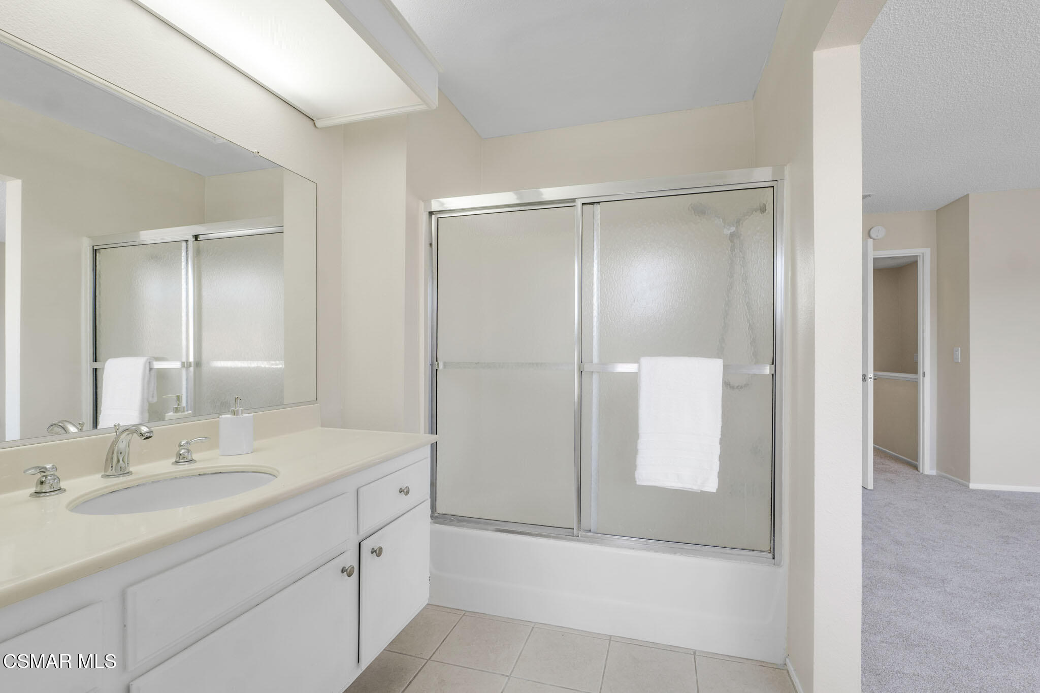 6635 Pecan Avenue Moorpark, CA 93021 - Photo 29 of 54 a bathroom with a double vanity sink mirror and shower