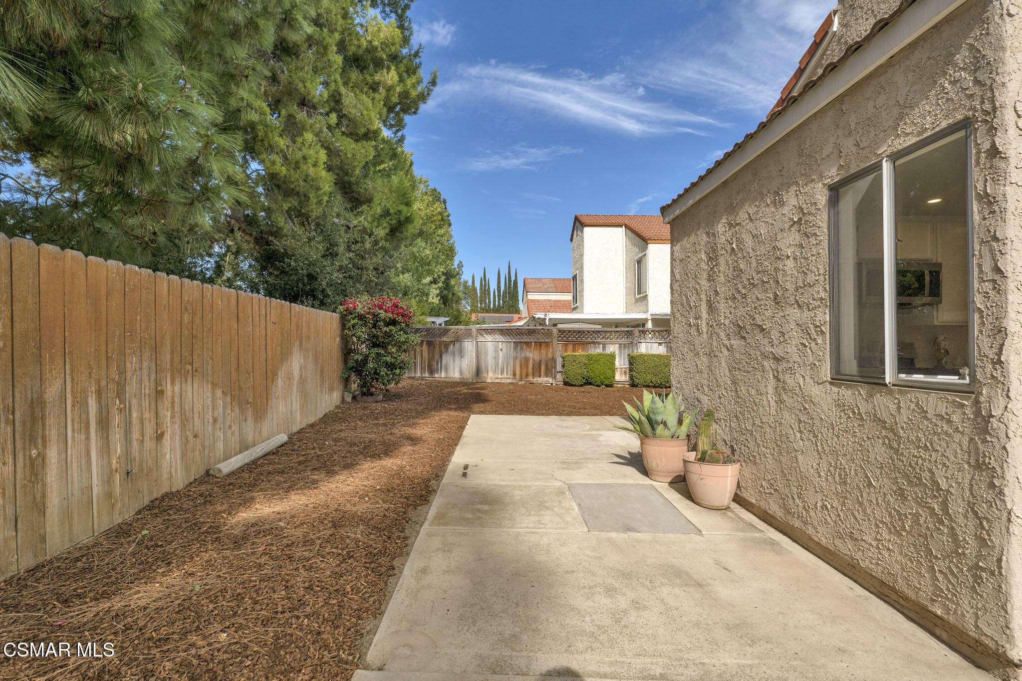 6635 Pecan Avenue Moorpark, CA 93021 - Photo 41 of 54 a view of a patio with table and chairs with wooden floor and fence