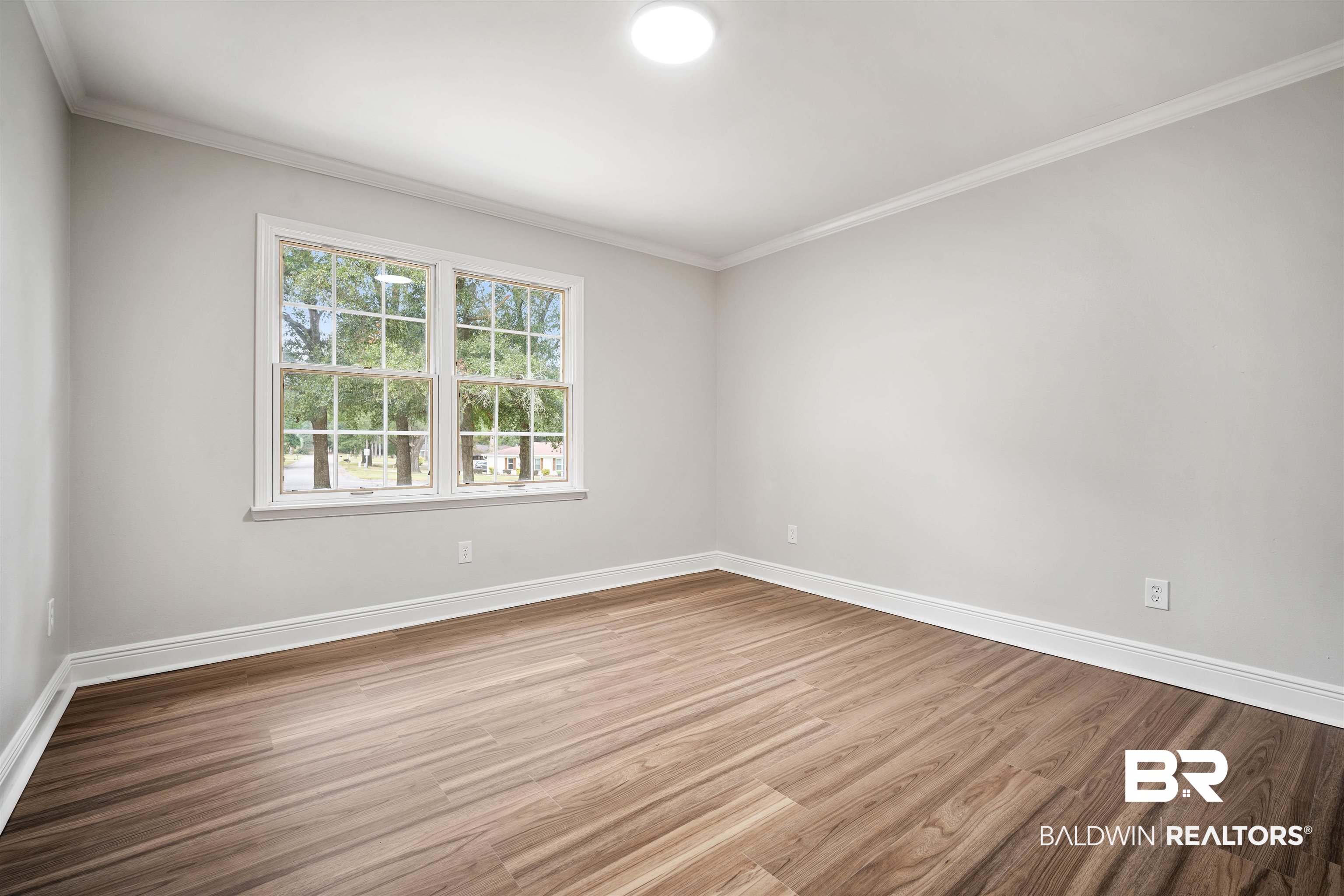 3050 Lacoste Road Mobile, AL 36618 - Photo 22 of 30 Unfurnished room featuring wood finished floors and crown molding