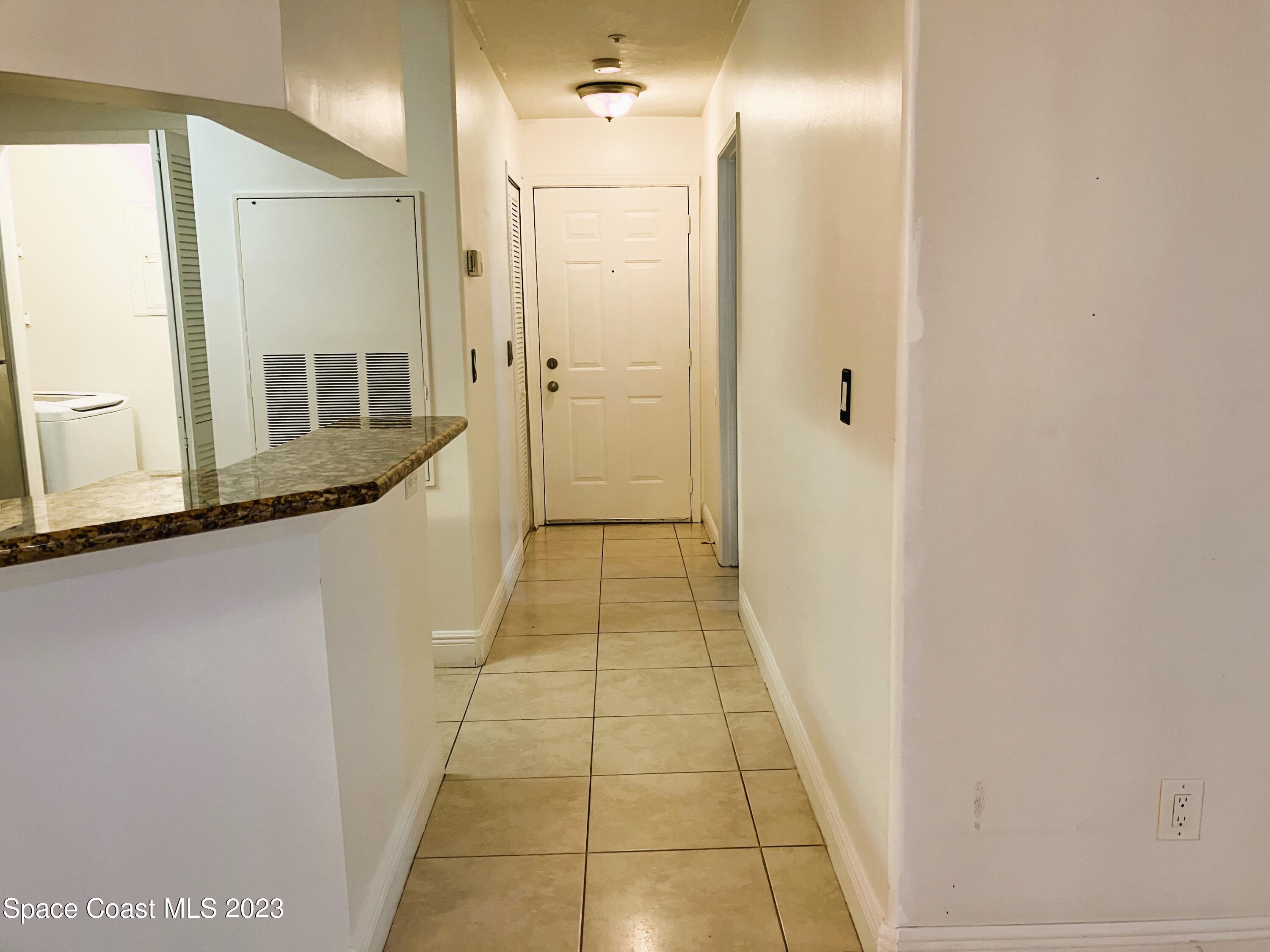 7667 North Wickham Road, Unit 304 Melbourne, FL 32940 - Photo 22 of 36 a bathroom with a granite countertop sink a mirror and a shower