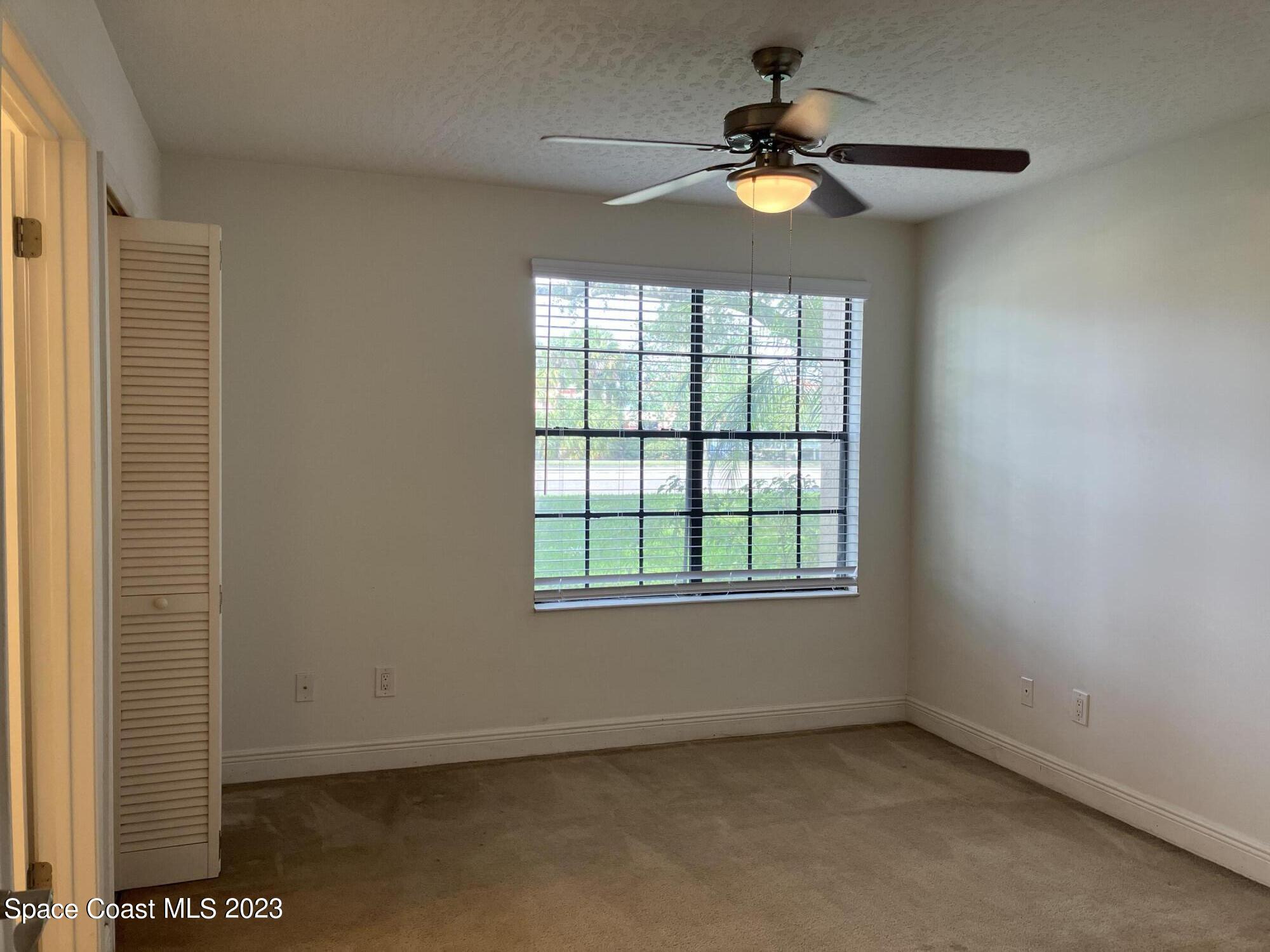 7667 North Wickham Road, Unit 304 Melbourne, FL 32940 - Photo 6 of 36 an empty room with a window