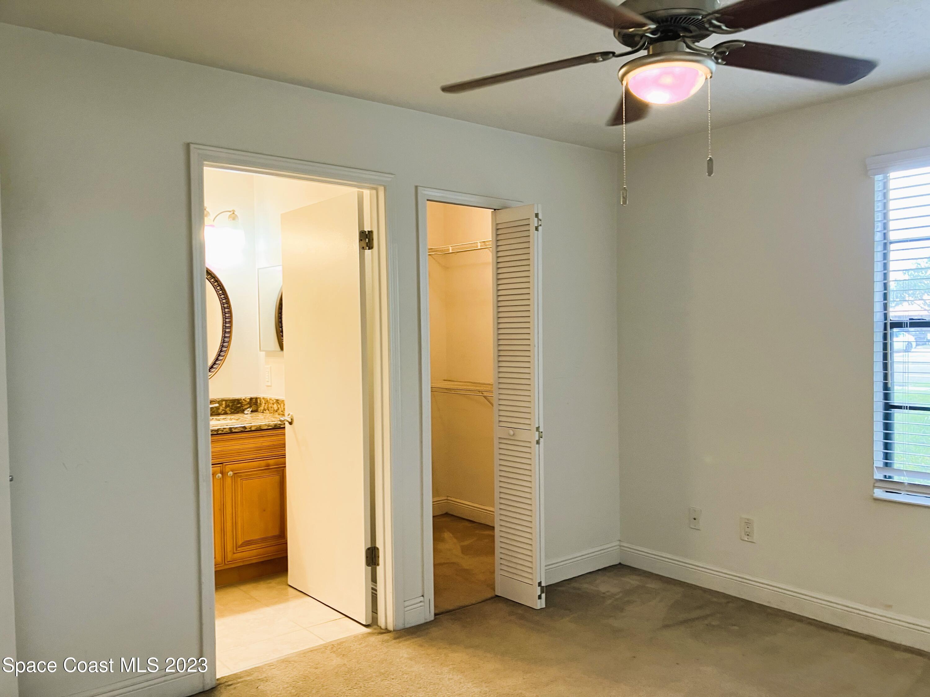 7667 North Wickham Road, Unit 304 Melbourne, FL 32940 - Photo 7 of 36 a view of walk in closet with window