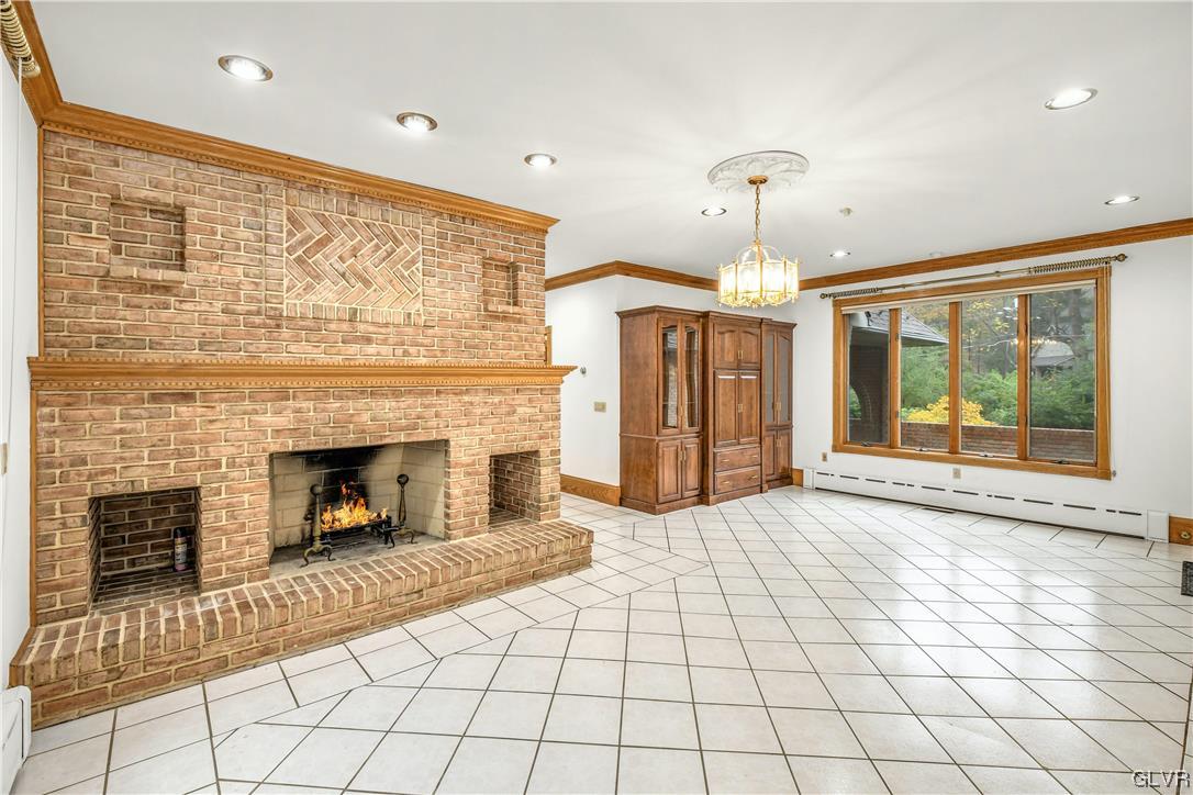 3166 Apollo Drive Bethlehem, PA 18017 - Photo 13 of 37 a view of a livingroom with a fireplace a chandelier and windows