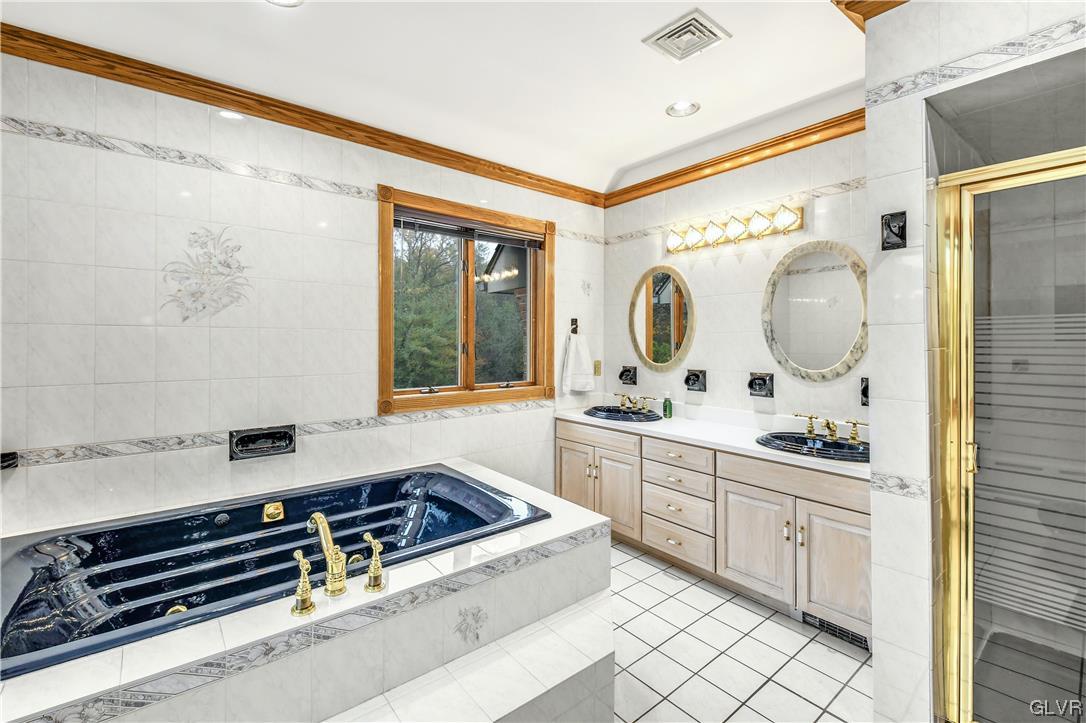 3166 Apollo Drive Bethlehem, PA 18017 - Photo 21 of 37 a spacious bathroom with a granite countertop sink mirror and a bathtub