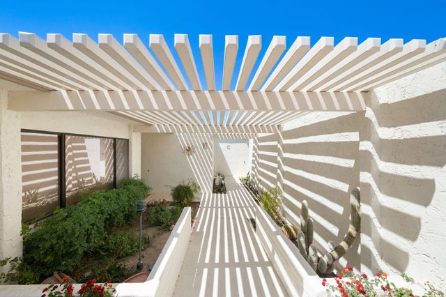 a view of a balcony with wooden floor and fence