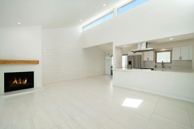 a view of a kitchen with refrigerator and windows