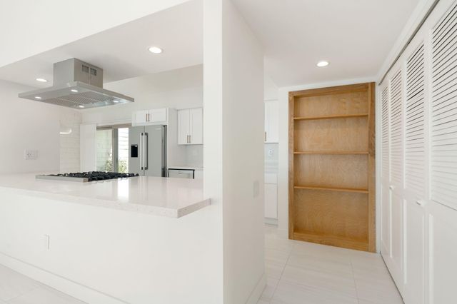 a kitchen with stainless steel appliances a sink and a refrigerator