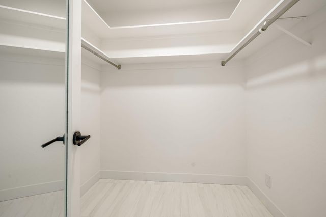 a white toilet sitting next to a shower