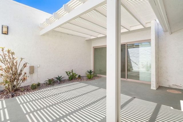 a view of a bedroom with wooden floor and chair