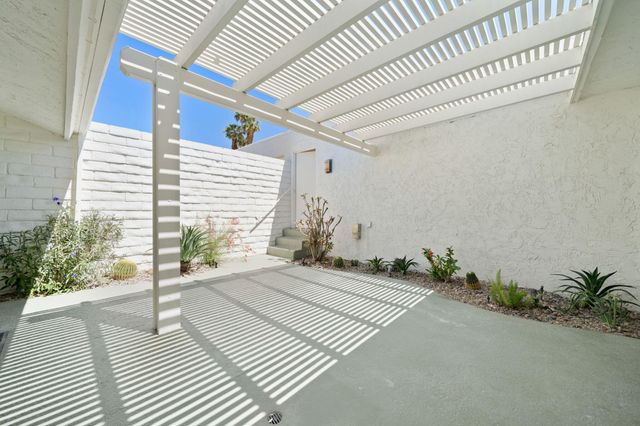 a potted plant is sitting in front of a house