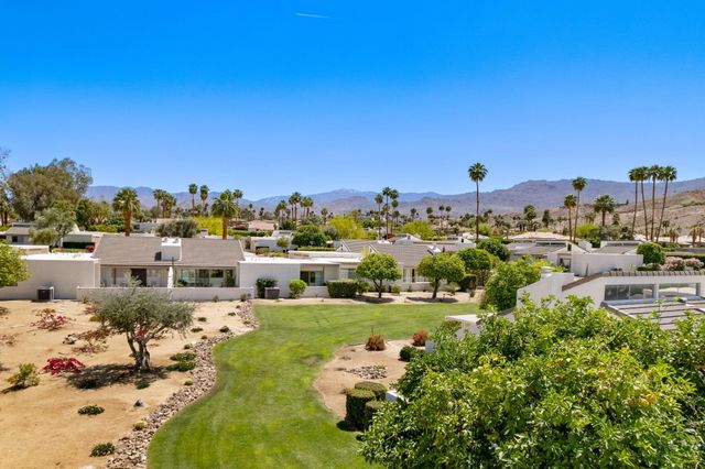 a front view of a house with yard and seating area