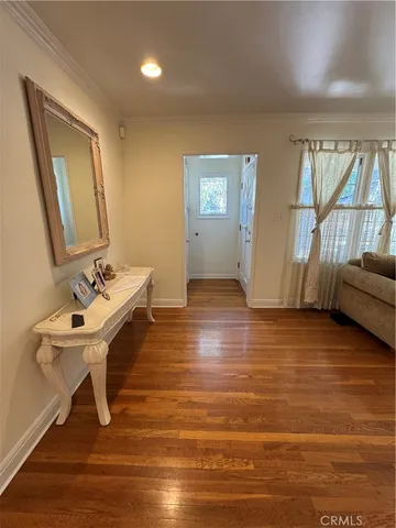 a room with a table chairs and wooden floor