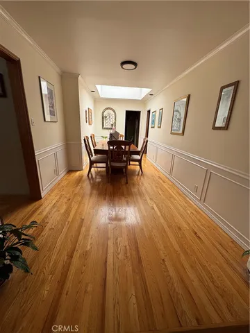 a view of dining room with furniture window and wooden floor