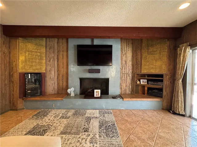 a view of a livingroom with a fireplace and cabinet