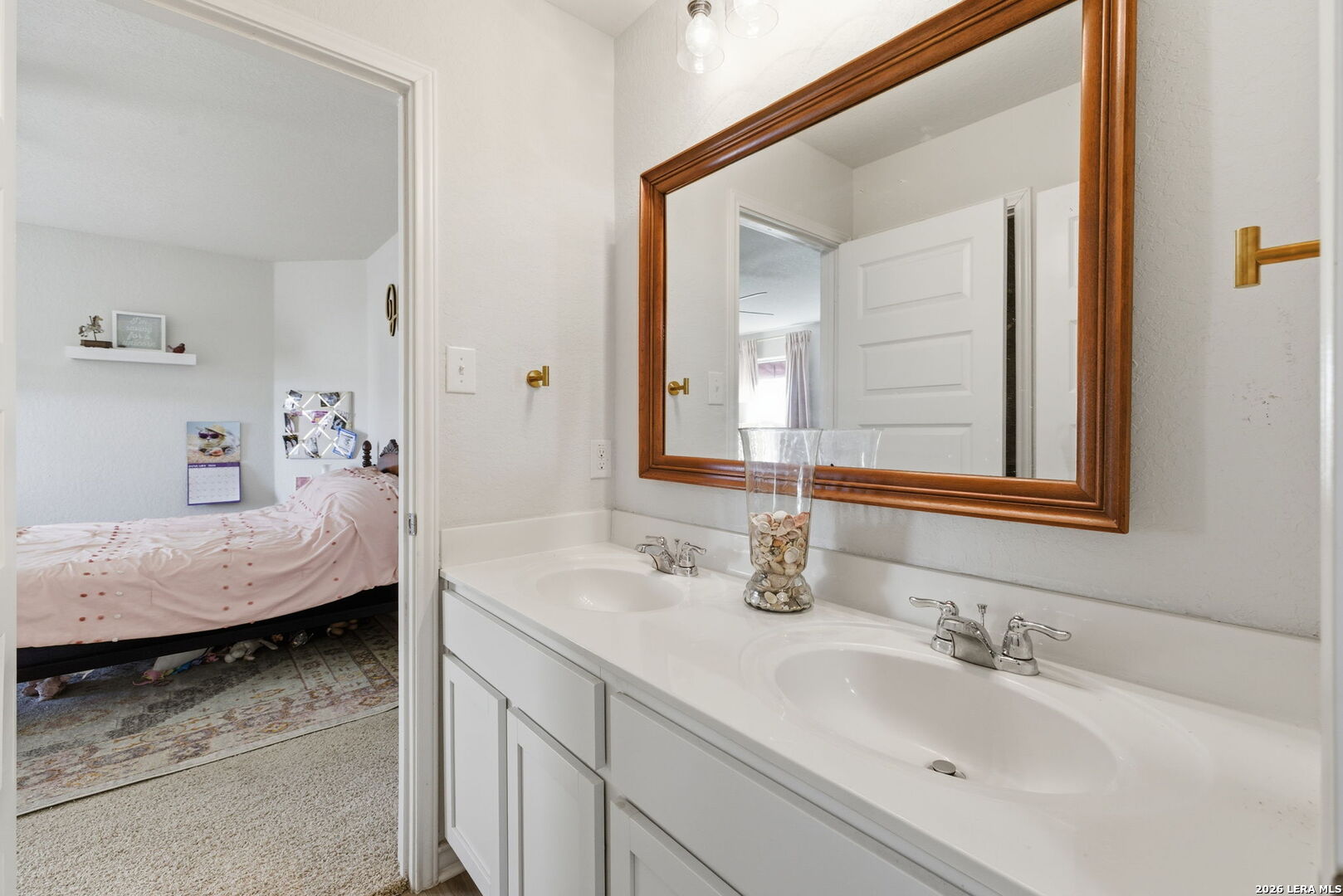3410 Copper Acres Bulverde, TX 78163 - Photo 27 of 50 a en suite bathroom with a double vanity sink and a mirror