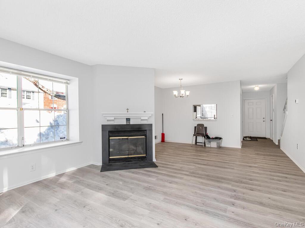 31 Winchester Avenue Peekskill, NY 10566 - Photo 20 of 33 a view of empty room with wooden floor and fireplace