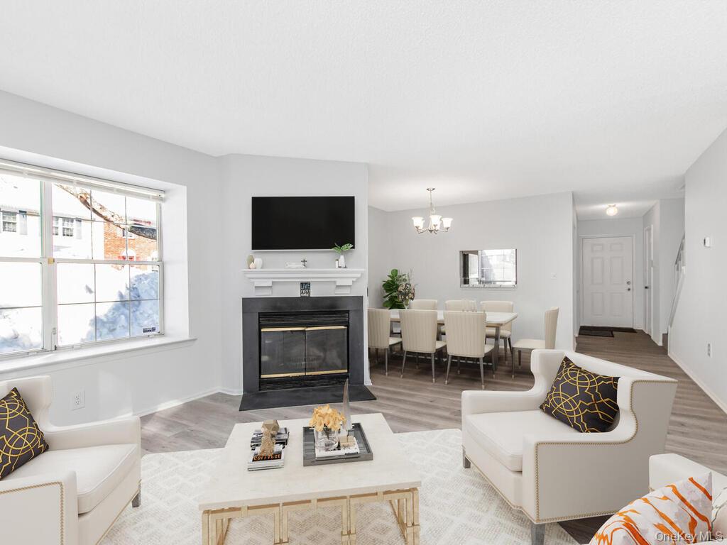 31 Winchester Avenue Peekskill, NY 10566 - Photo 33 of 33 a living room with furniture a flat screen tv and a fireplace
