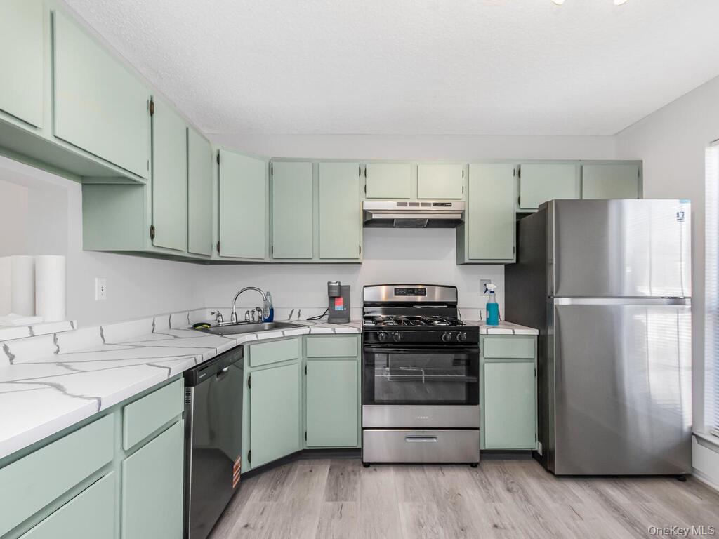 31 Winchester Avenue Peekskill, NY 10566 - Photo 4 of 33 a kitchen with a sink appliances and cabinets