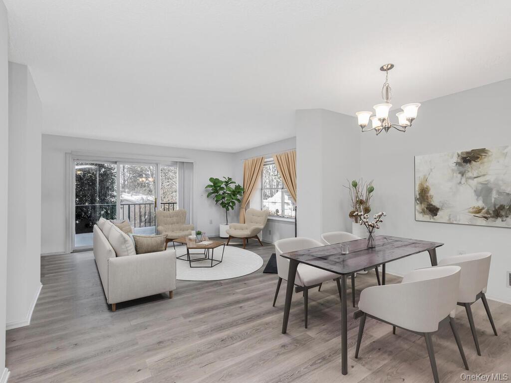 31 Winchester Avenue Peekskill, NY 10566 - Photo 5 of 33 a living room with furniture and a chandelier