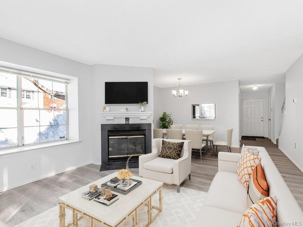 31 Winchester Avenue Peekskill, NY 10566 - Photo 6 of 33 a living room with furniture a fireplace and a flat screen tv